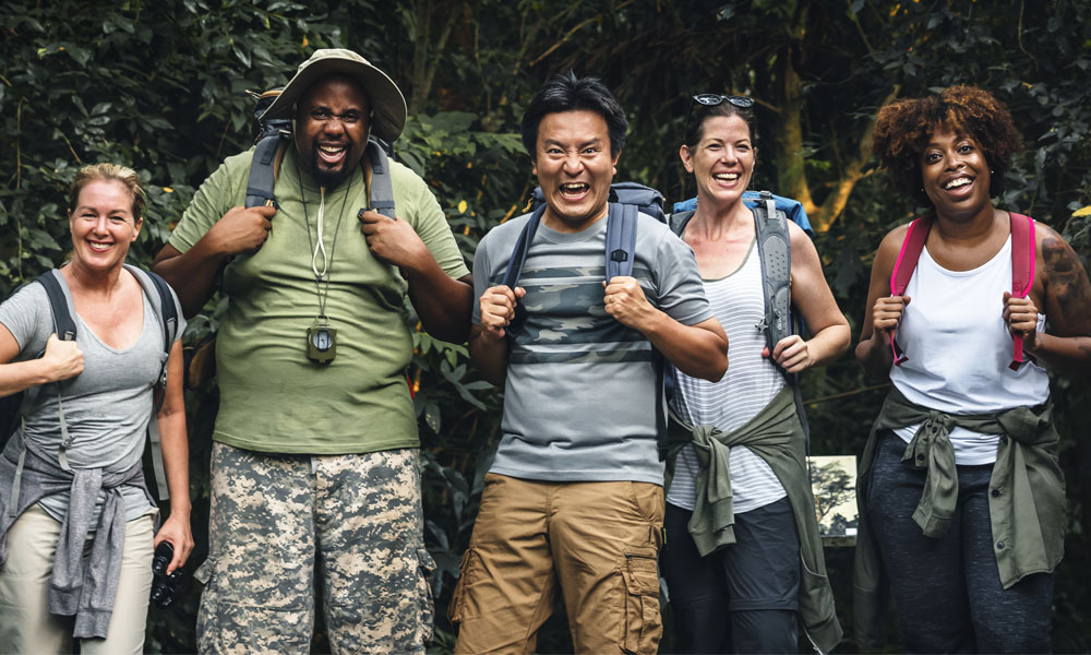 Group of happy campers going on hike